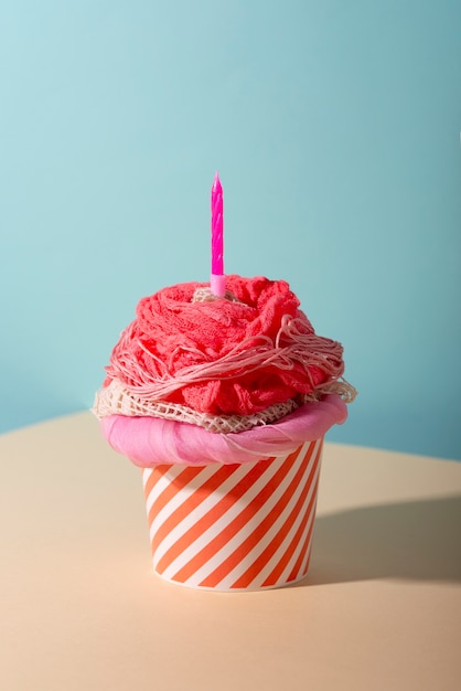 Photo fast fashion concept with materials and textiles disguised as cupcake