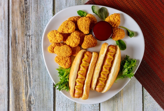 Fast food concept. Hot dog with chicken nuggets.