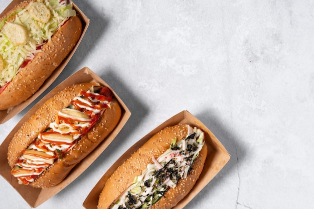 fast food hot dog banner on a light grey stone textured background, hotdog menu template