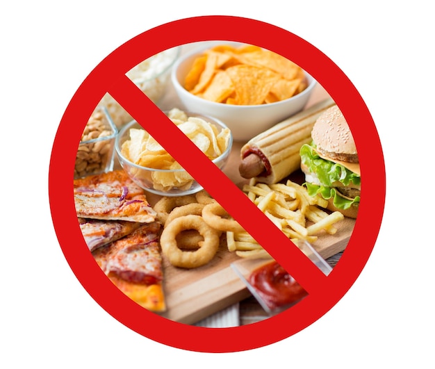 Photo fast food, low carb diet, fattening and unhealthy eating concept - close up of fast food snacks and cola drink on wooden table behind no symbol or circle-backslash prohibition sign