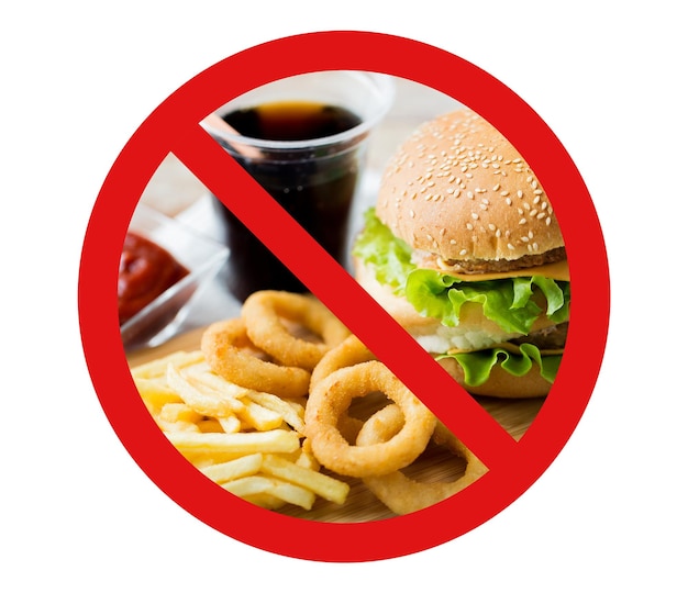 Photo fast food, low carb diet, fattening and unhealthy eating concept - close up of hamburger or cheeseburger, deep-fried squid rings and french fries behind no symbol or circle-backslash prohibition sign