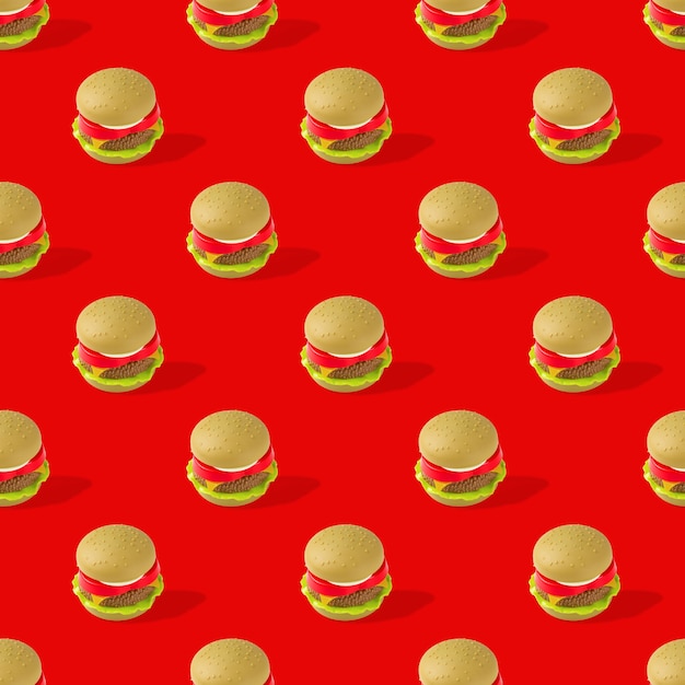 fast food. seamless pattern of plastic childrens toy burger with salad, tomato, meat on red back