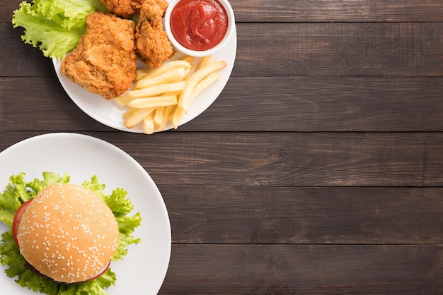 Fast food set fried chicken,french fries and hamburger on wooden background