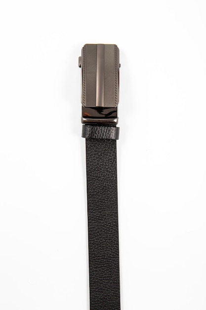 Fastened fashionable mens leather belt with dark matted metal buckle on white background