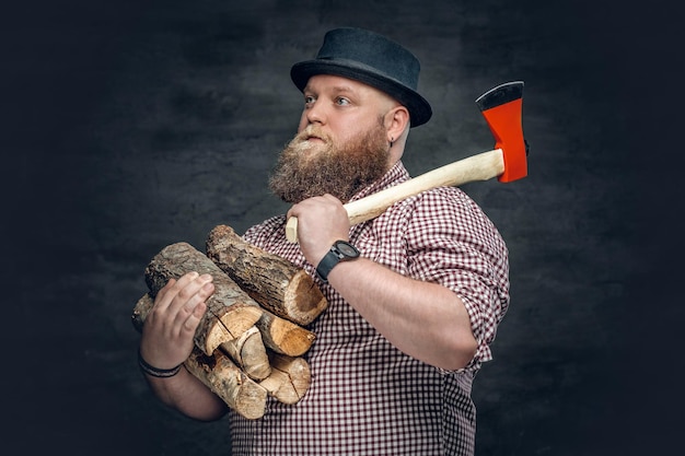 Fat bald, bearded man holds an axe and fire woods.