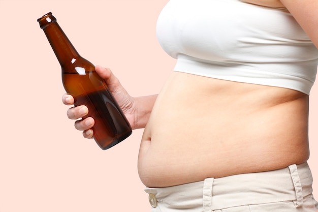 A fat belly woman with a beer in her hand