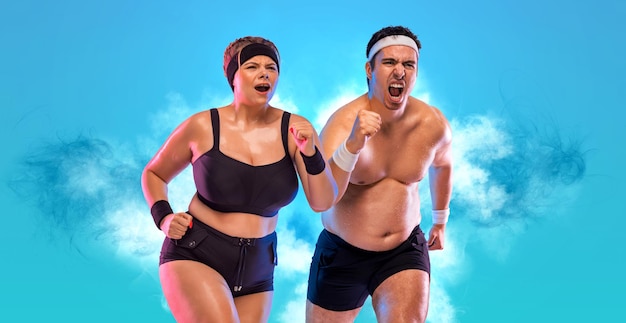 Fat couple in love doing fitness to look their best Man and woman runners on blue background