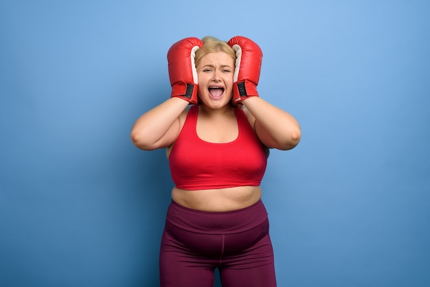 Fat girl is worried because she cannot lose weight . purple background