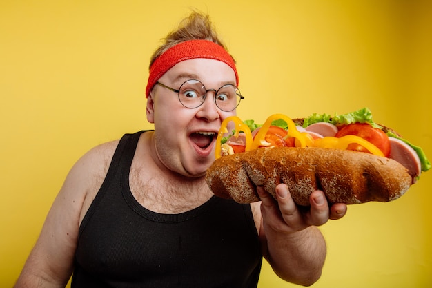 Fat man eating fast food hamburger