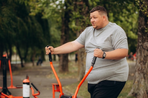 Fat man slowly running outdoors active lifestyle as struggle with obesity High quality photo