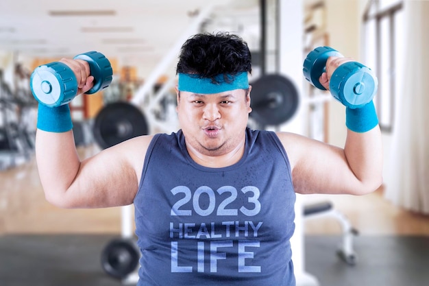 Fat man standing with text of 2023 healthy life