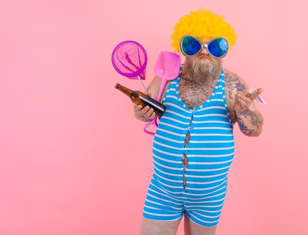 Fat man with beard and wig smokes cigarettes and drinks beer