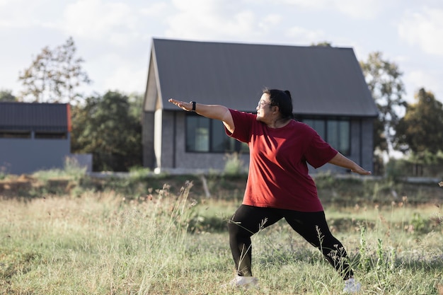 Donna grassa asia che fa yoga a casa