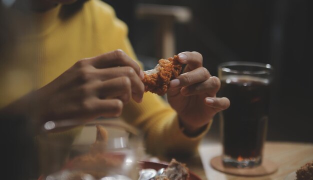 Photo fat woman bite piece of pizzaoverweight female is eating fast foodsasian girl is hungry