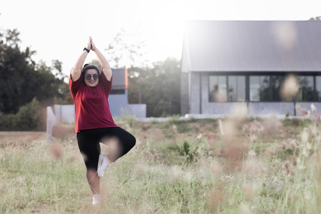 Fat woman doing yoga at home