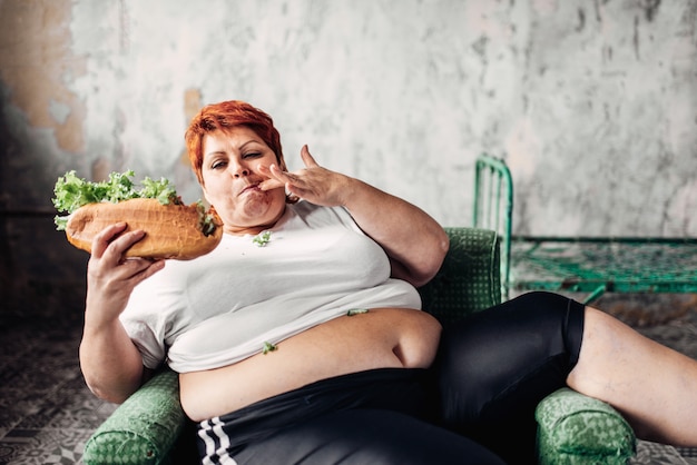 Fat woman eats sandwich, overweight, fatty