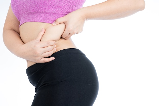 Fat woman holding excessive fat belly from lower back isolated