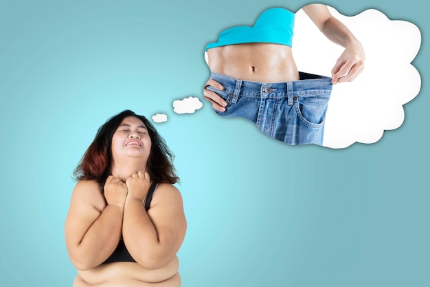 Fat woman imagining her dream to get slim body