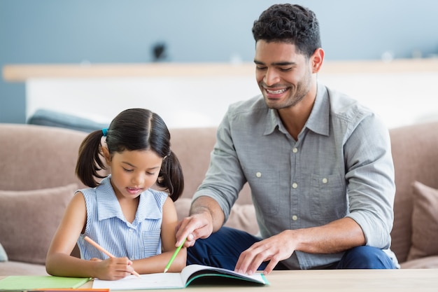 Father assisting her daughter in doing her homework