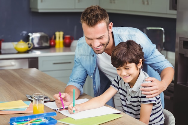 Father assisting son to do homework