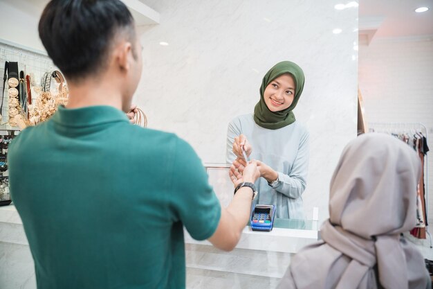 Father buying new clothes for his daughter in the shop