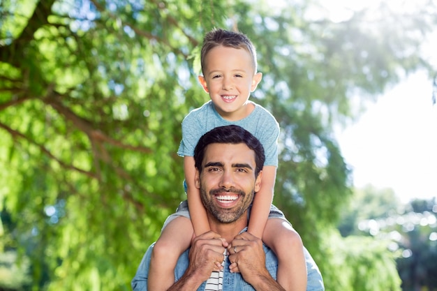 Father carrying son on his shoulders