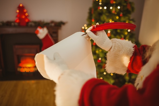 Father christmas writing with a quill