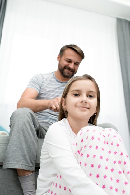 Father Combing Girls Hair