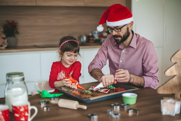 Father and daughter baking Christmas cookies