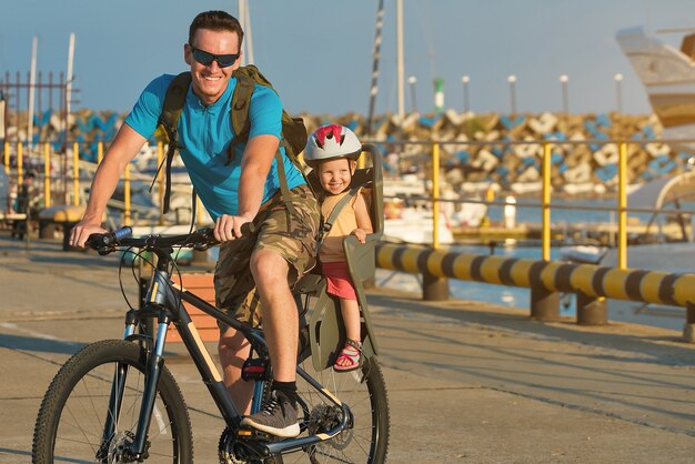 Father and daughter on a bike bicycle childseat