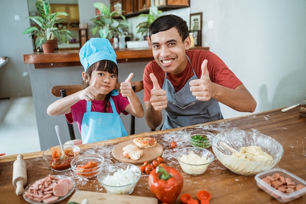 Father and daughter cooking together