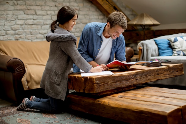 Father and  daughter doing homework at home