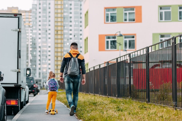 Father and daughter going to school for the first time. Back to school after pandemic.