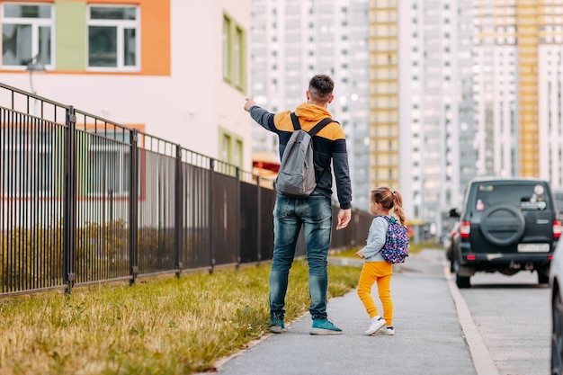 Father and daughter going to school for the first time. Back to school after pandemic.