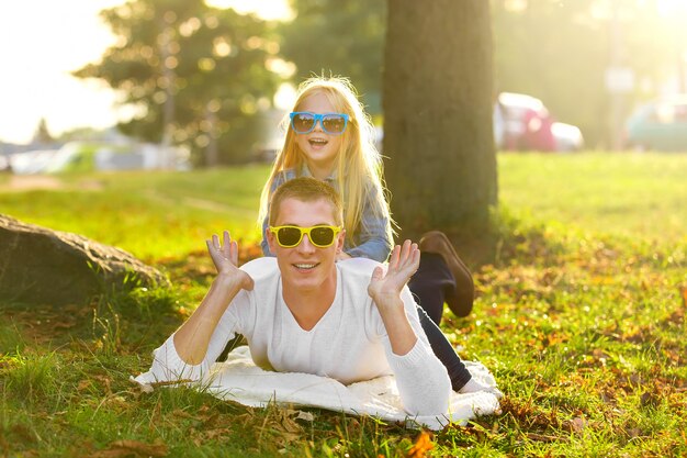 Father and daughter on the grass in the park