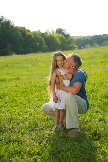 Father and daughter on a green meadow.