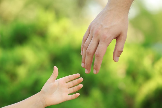 Father and daughter hands outdoors