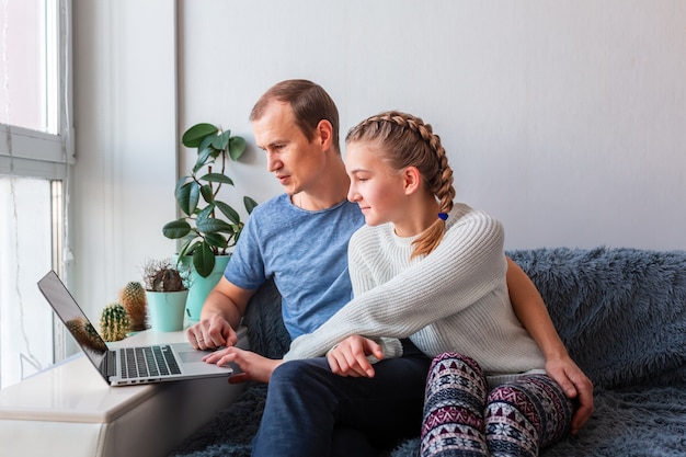 Father and daughter having video call with grandparents on laptop  Stay at home, distance communication concept