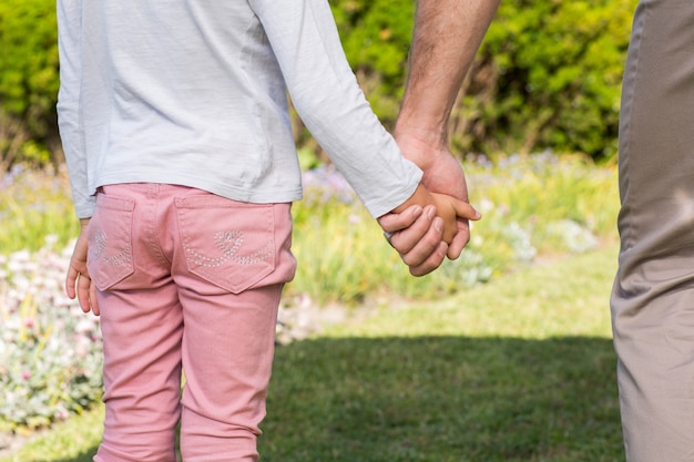 Father and daughter holding hands