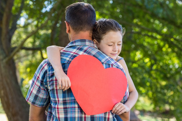 Father and daughter hugging in the park