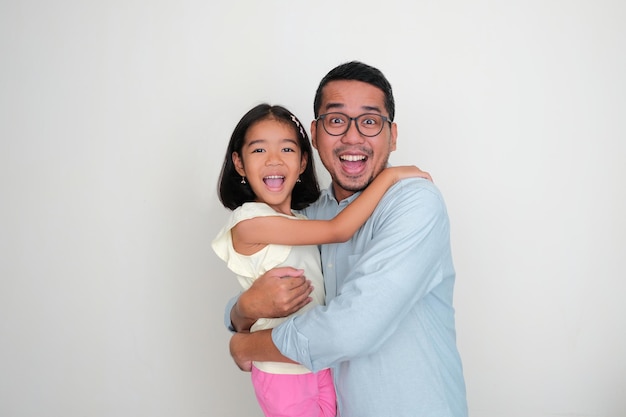 A father and daughter hugging together with happy face expression