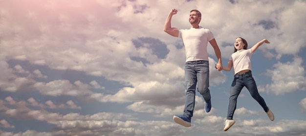 Father and daughter jump on sky banner with copy space happy father and daughter jump in sky freedom