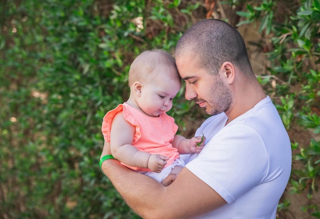 Father and daughter leaned their heads to each other