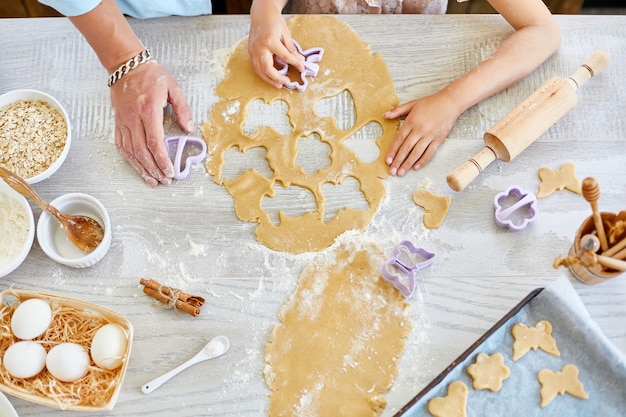 Father and daughter make cookies by mold