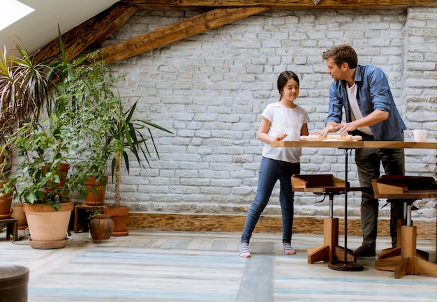 Father and daughter making bread in the kitchen