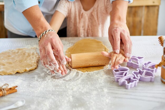 Father and daughter making cookies together