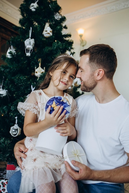 Father and daughter near the Christmas tree