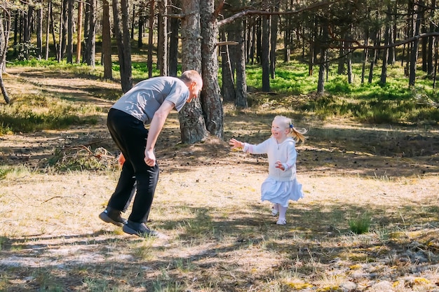 Father and daughter playing in a spring forest Active people are having a good time outdoors