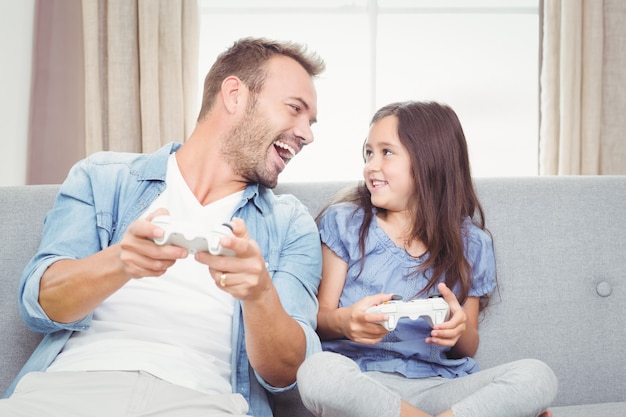 Father and daughter playing video game