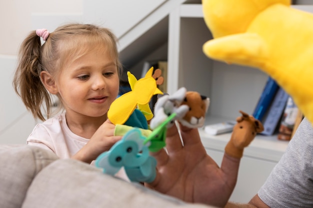 Photo father and daughter playing with puppets